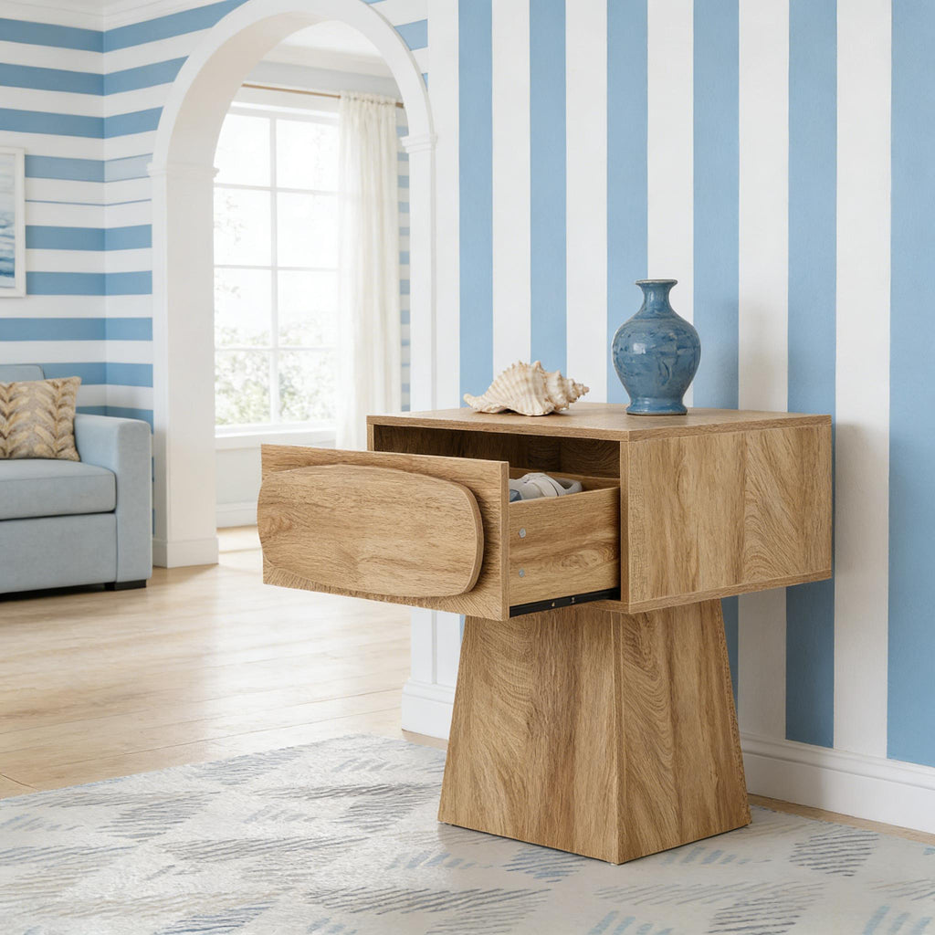 Pedestal side table with its drawer open in a room with blue striped walls