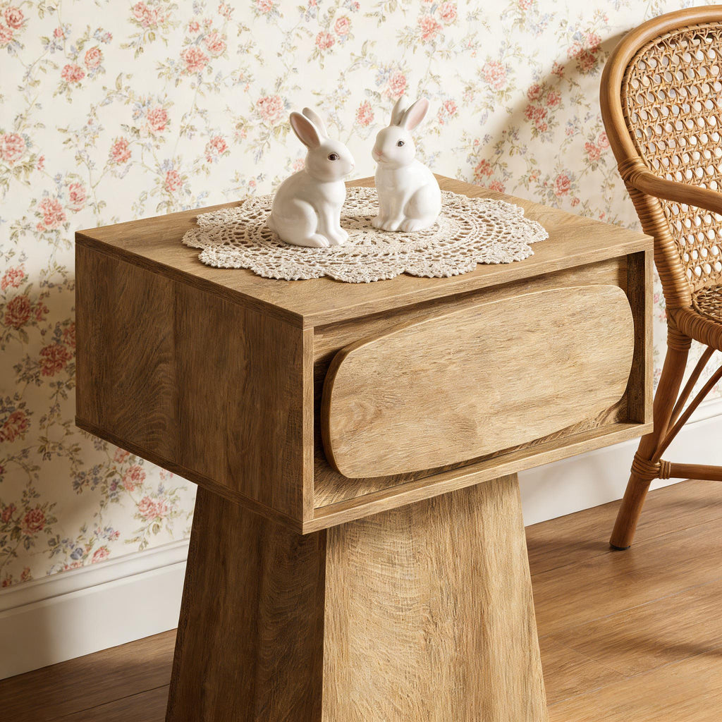 Pedestal side table — detail of the rounded drawer front against floral wallpaper