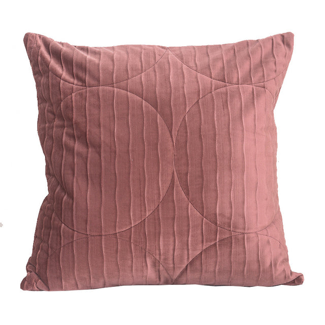 Quilted velvet pillow cover in dusty rose, square, circle and channel stitching, on a plain white background