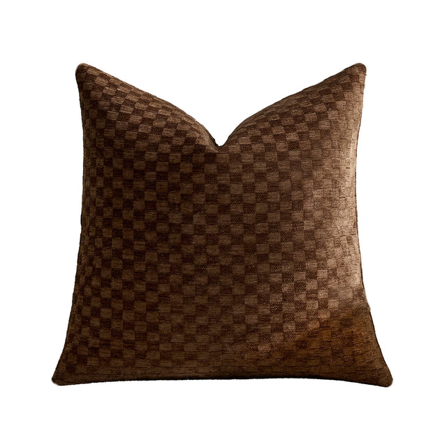 Raised checkerboard chenille pillow cover in chocolate brown on a plain white background