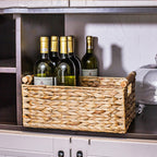 Large woven storage basket holding wine bottles upright on a cabinet shelf