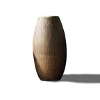 Ribbed wood-grain ceramic vase, oval shape with pale rim, on a plain white background