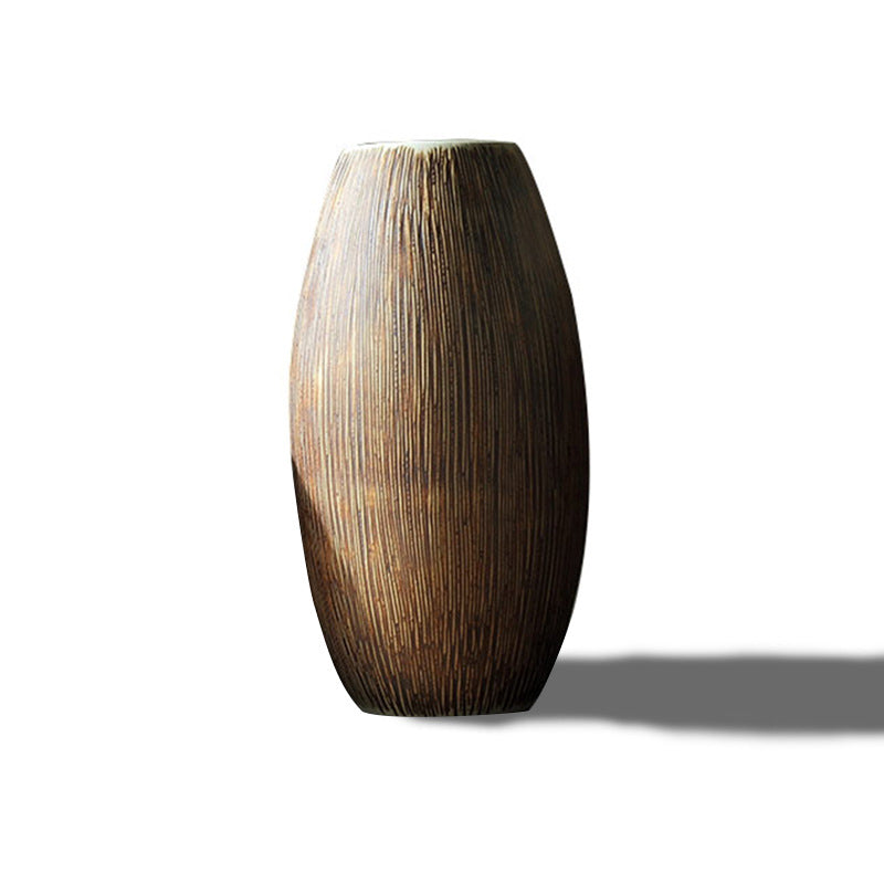 Ribbed wood-grain ceramic vase, oval shape with pale rim, on a plain white background