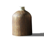 Ribbed wood-grain ceramic vase, shouldered jar shape with ivory neck, on a plain white background