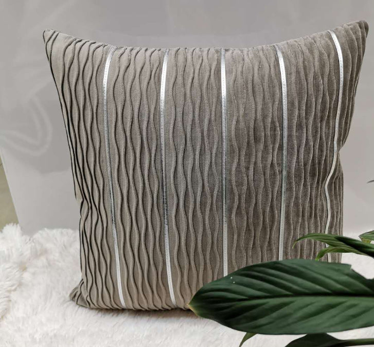 Smoke grey rippled velvet pillow cover with silver stripes on a white rug