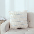 White rippled velvet pillow cover with metallic stripes on a white sofa