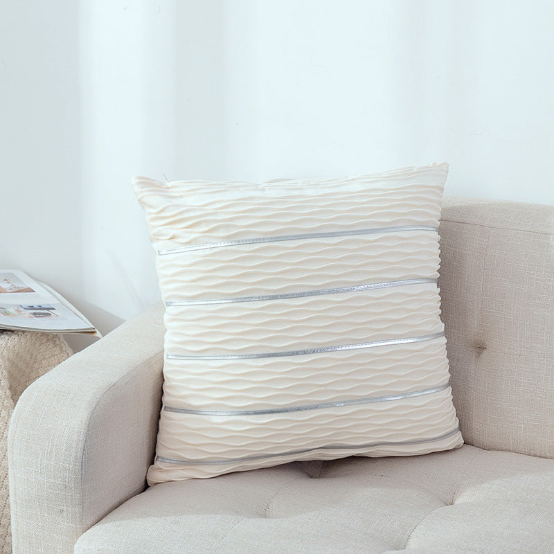 White rippled velvet pillow cover with metallic stripes on a white sofa
