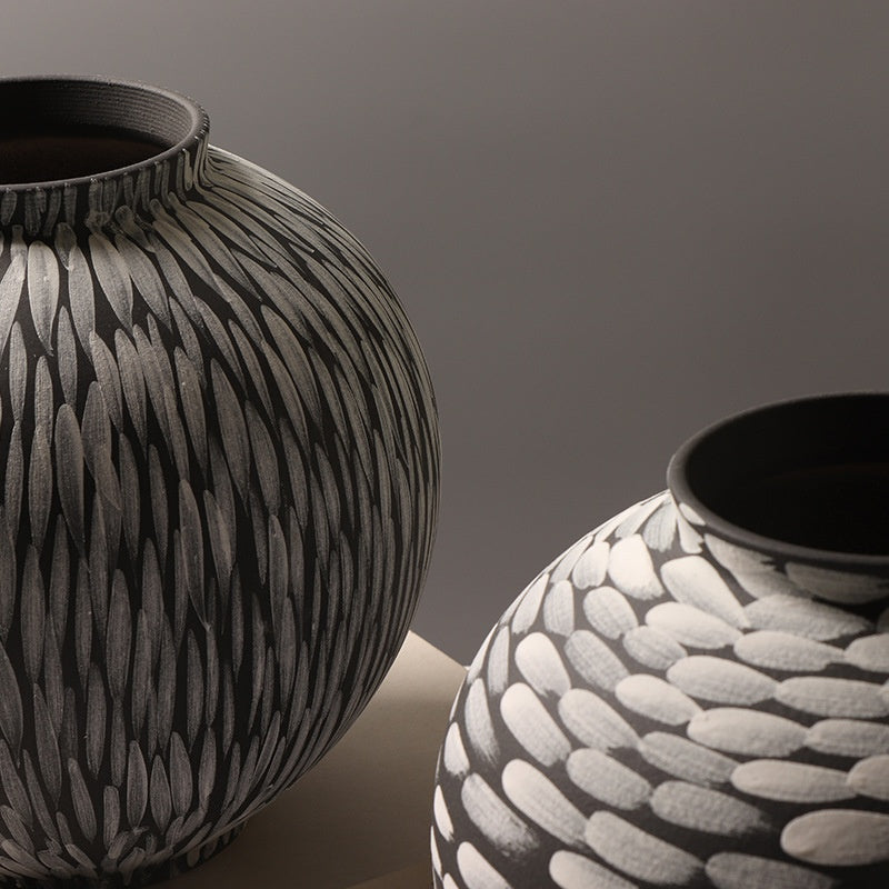 Round brushstroke ceramic vases in charcoal and cream — detail of the vertical feather and horizontal dab patterns