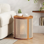 Round cane drum side table beside a cream sofa with a cactus, a book and a cup