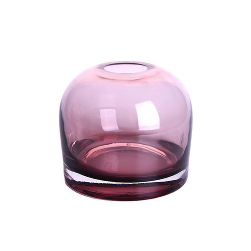 Rounded bell glass bud vase in dusty rose, 4.7 in size, with a thick clear base on a plain white background