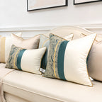 Teal satin patchwork pillow covers in lumbar and square sizes on a cream sofa