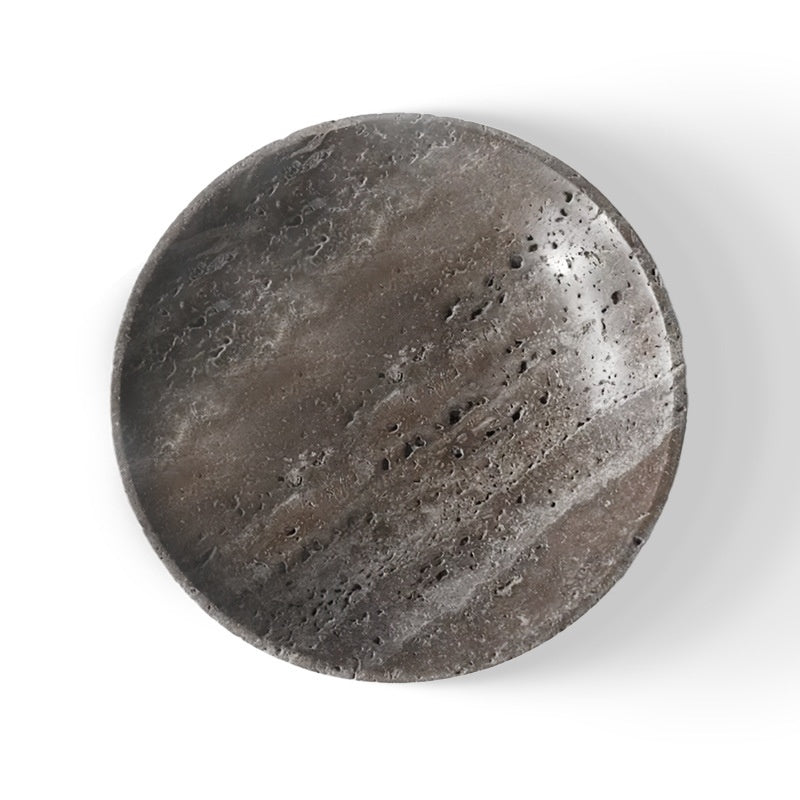 Silver gray travertine shallow bowl seen from above, showing banded stone, on a white background