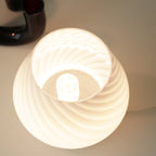 Swirl glass mushroom table lamp — view into the lit shade showing the bulb