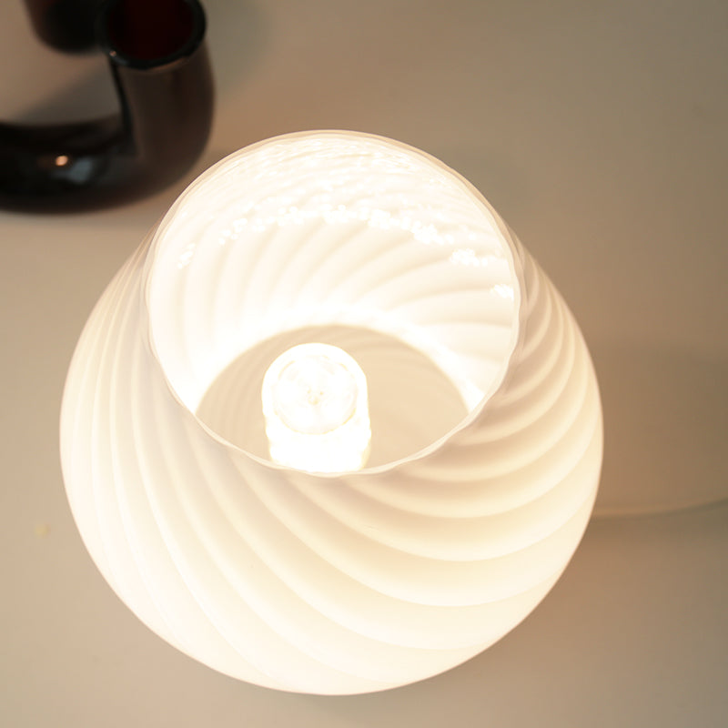 Swirl glass mushroom table lamp — view into the lit shade showing the bulb