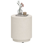 Speckled concrete-look drum side table on a plain white background, styled with a vase of roses and a book