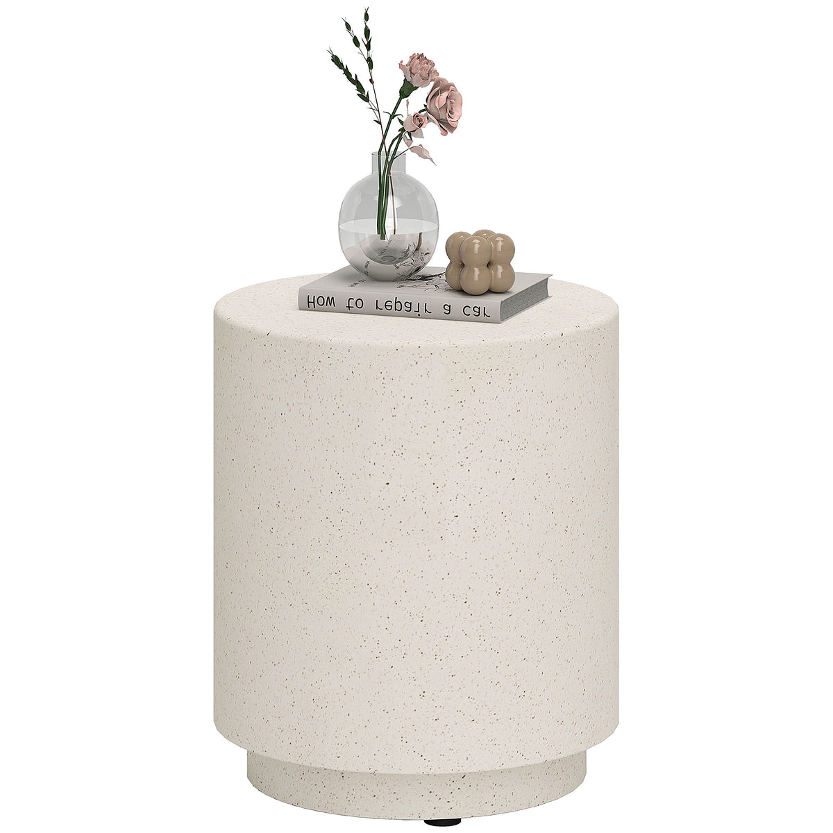 Speckled concrete-look drum side table on a plain white background, styled with a vase of roses and a book