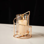 Short spiral hurricane candle holder lit with a pillar candle — detail of the gold-tone rail