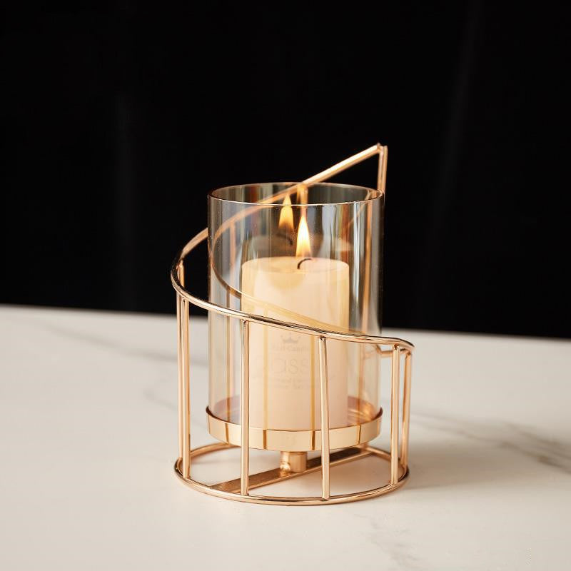 Short spiral hurricane candle holder lit with a pillar candle — detail of the gold-tone rail