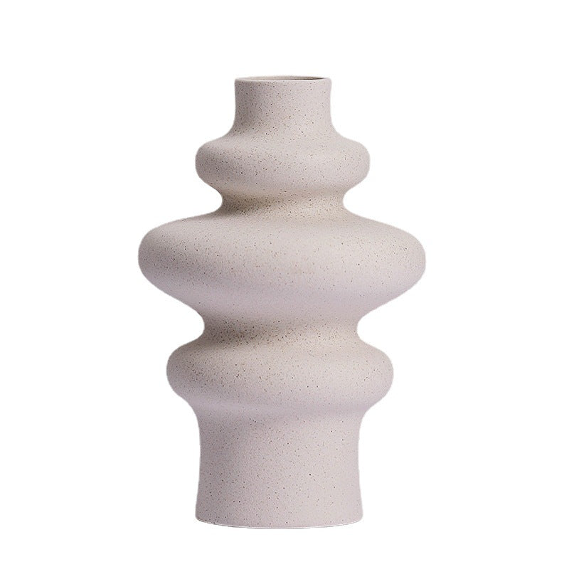 Stacked ring ceramic vase, three ring style, in speckled matte cream on a plain white background