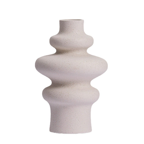 Stacked ring ceramic vase, three ring style, in speckled matte cream on a plain white background