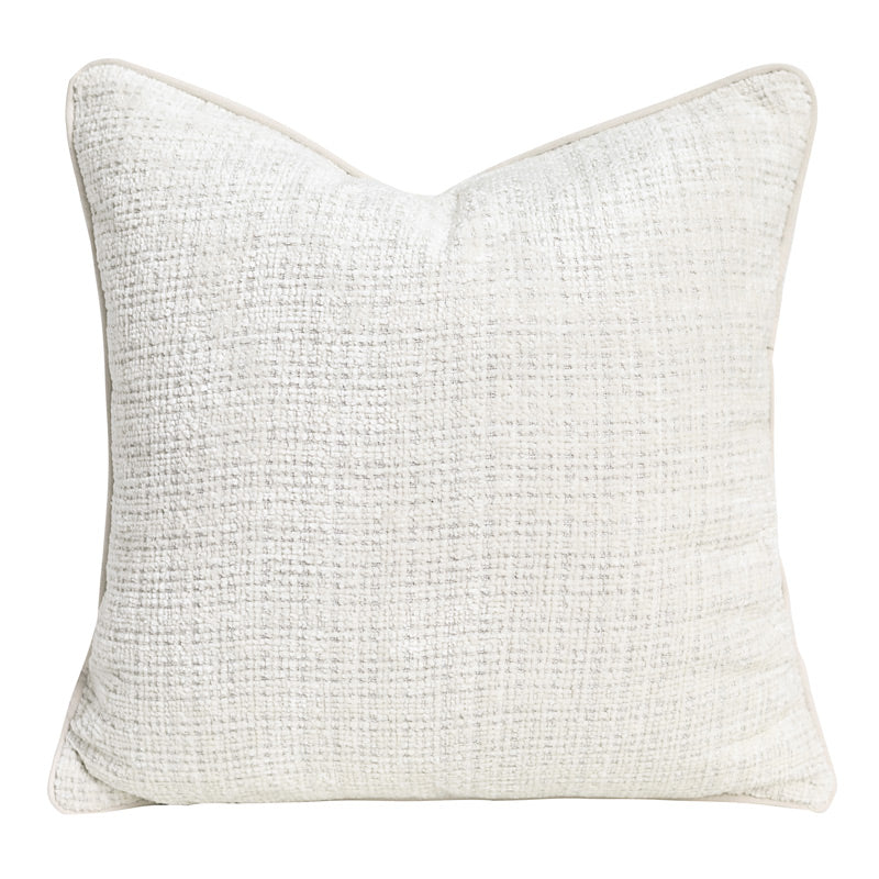 Textured chenille pillow cover in ivory, square, with piped edge on a plain white background