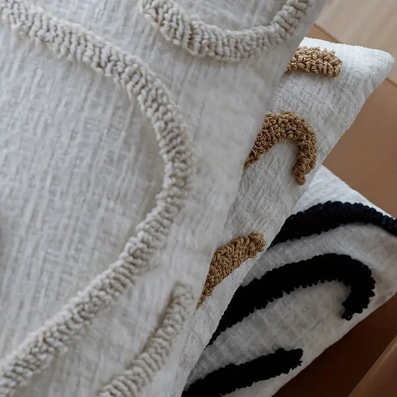 Tufted abstract line pillow covers in beige, camel and black, detail of the raised loop-pile lines