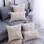 Cream tufted pillow covers in several patterns on a grey sofa (each sold separately)