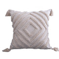 Square cream tufted pillow cover, concentric diamond pattern, corner tassels, on a white background