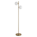 Twin globe floor lamp with white glass shades and a gold-tone steel pole on a plain white background