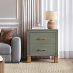 Olive green two-drawer nightstand beside a gray armchair under a linen-shade lamp