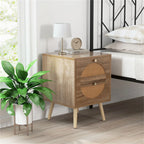Two-drawer rattan nightstand beside a bed with a lamp, clock and potted plant