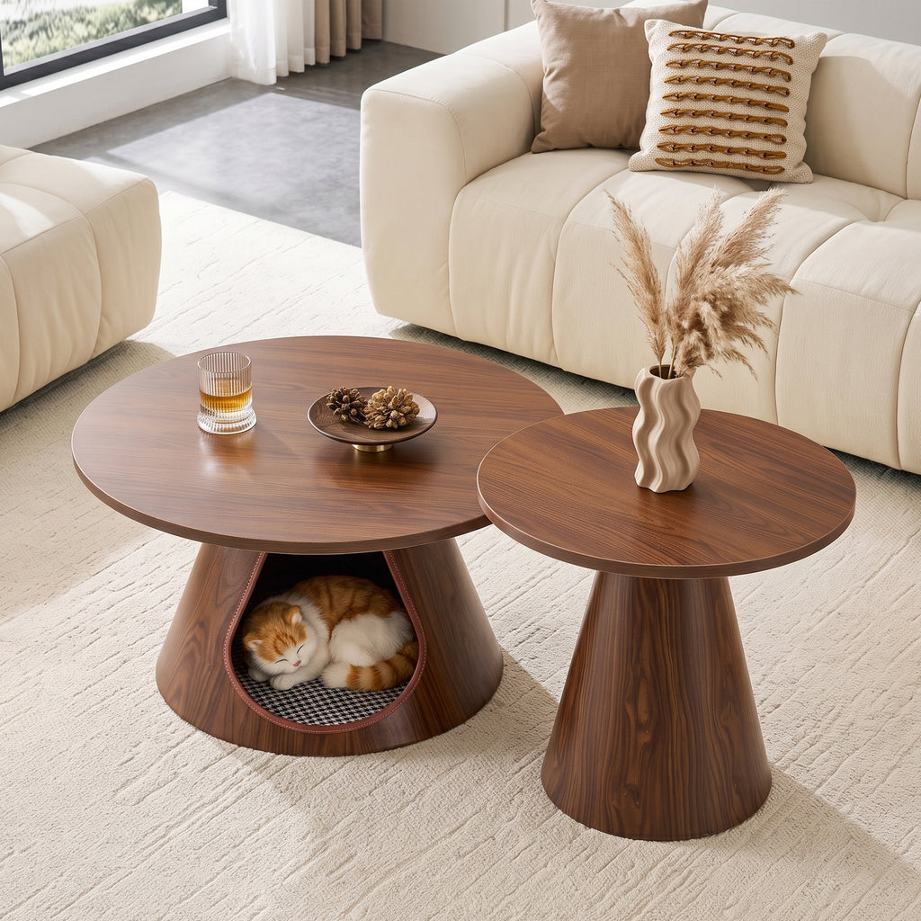 Cone nesting coffee tables in walnut finish on a cream rug, a cat curled in the cushioned cave