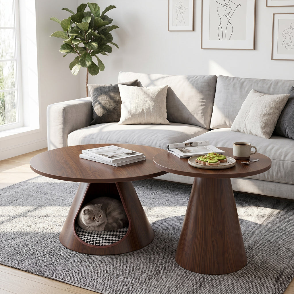 Two walnut-finish cone tables nested together before a grey sofa, a cat resting in the cave