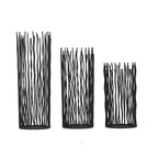 Black wavy iron rod pillar candle holders in small, medium and large on a plain white background