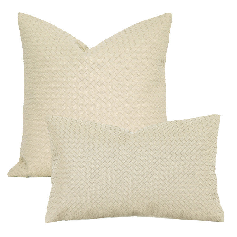 Cream woven faux leather pillow covers in square and lumbar sizes on a white background