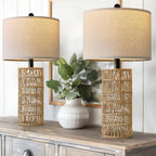 Two woven rattan table lamps on a whitewashed dresser with a green plant (each sold separately)