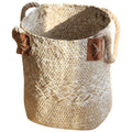 Whitewashed sand seagrass plant basket with rope handles on a plain white background